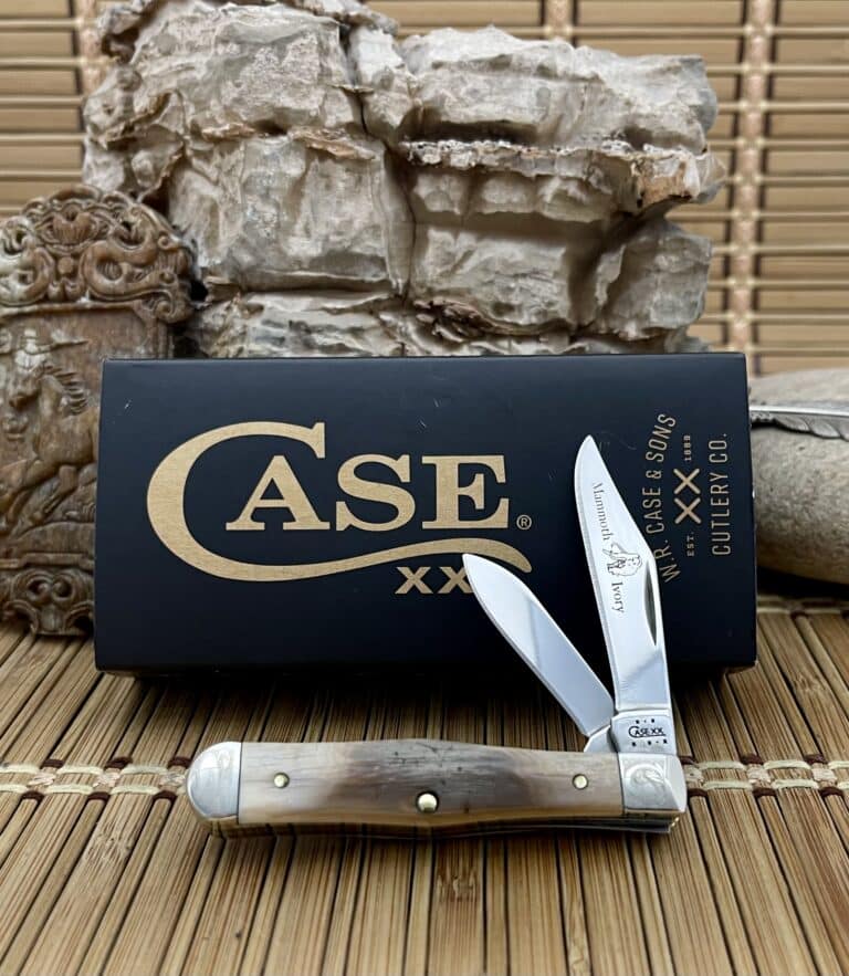 Case XX Swell Center Jack pocket knife with a mammoth fossil handle and scrolled bolsters, shown open in front of its Case box