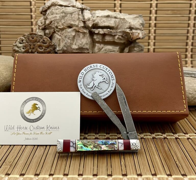 Case XX Baby Doc customized by Wild Horse Custom with an abalone and bloody jasper handle, shown open in front of a Wild Horse Custom presentation box
