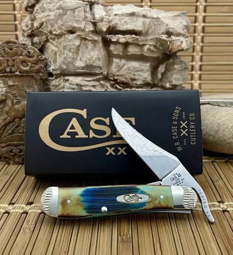 Case XX Russlock pocket knife with a blue and tan sawcut bone handle, shown open in front of its Case box
